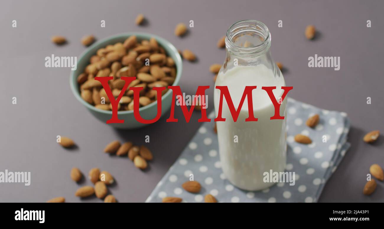 Image of yummy text over milk and nuts Stock Photo