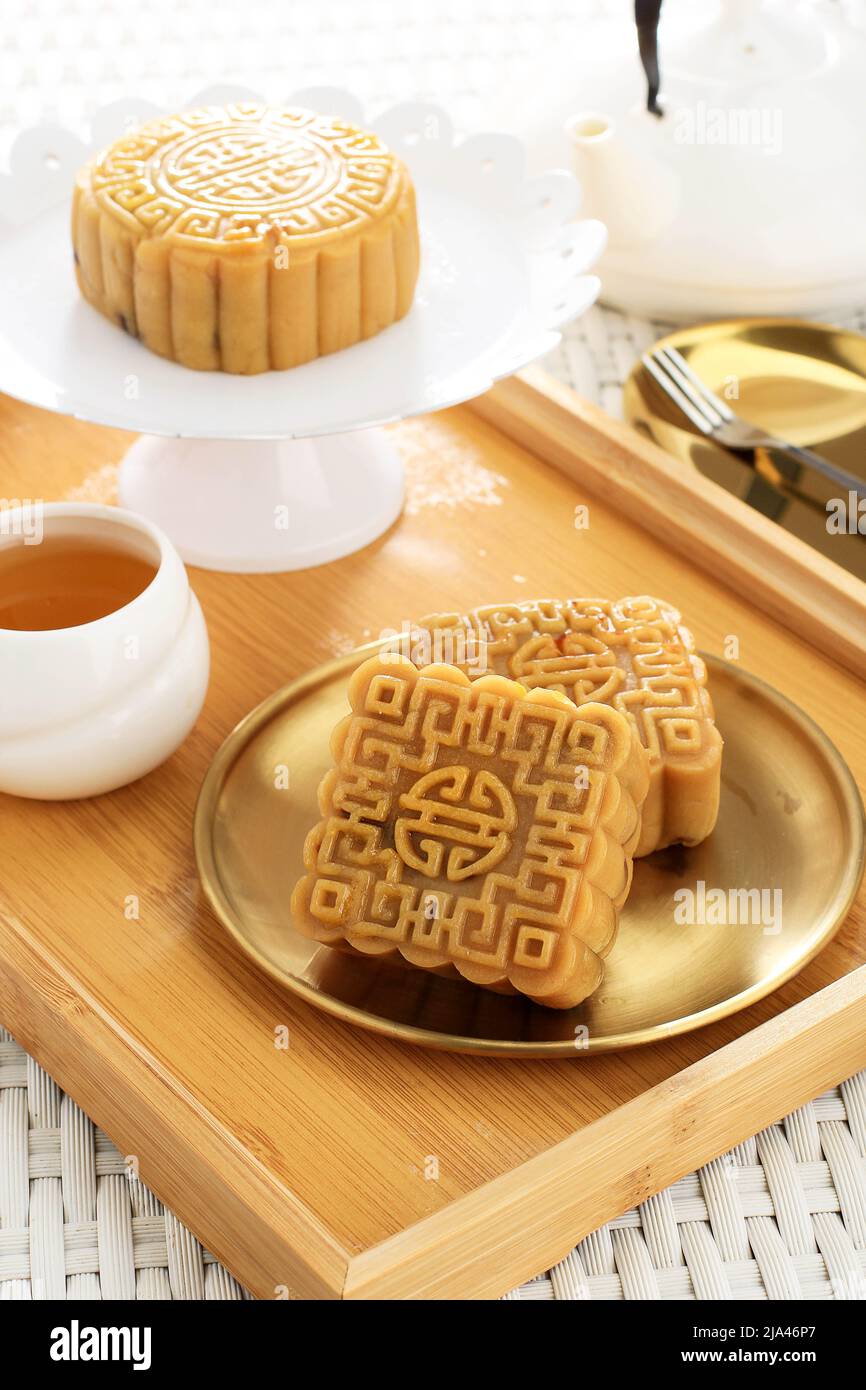 Delicious Mooncake, Traditional Chinese Sweet Snack for Mid Autumn Festival on the Table, Served with Tea Stock Photo