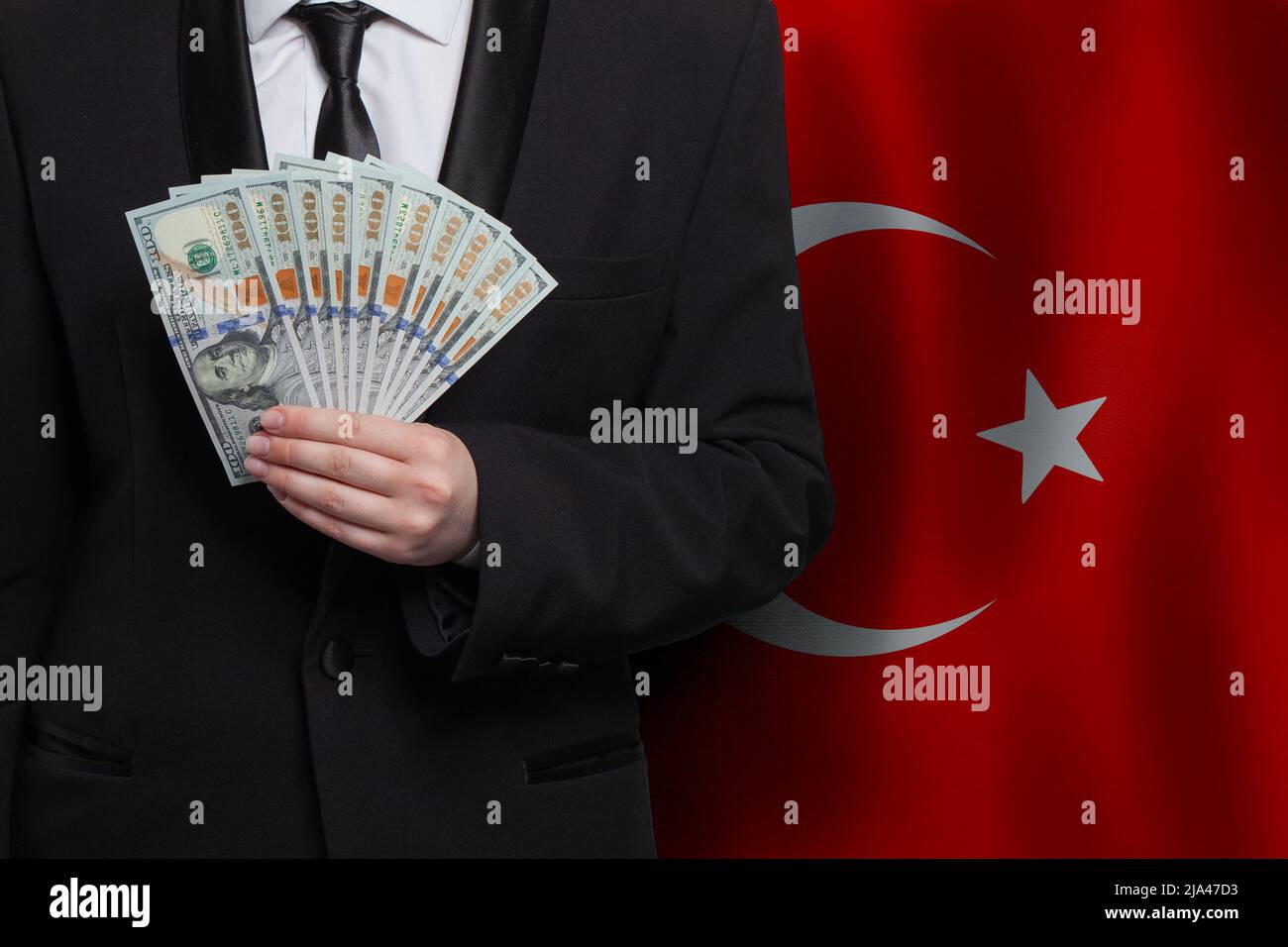 Turkish business man showing 100 US dollar bills money banknotes