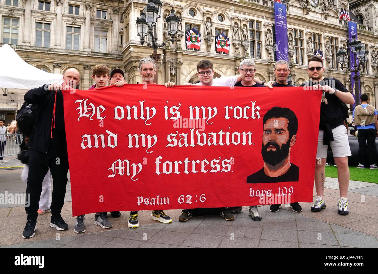 Liverpool fans pose with a flag of support at the Trophy Experience at The Place de l'Hotel de Ville in Paris ahead of Saturday's UEFA Champions League Final at the Stade de France, Paris. Picture date: Friday May 27, 2022. Stock Photo
