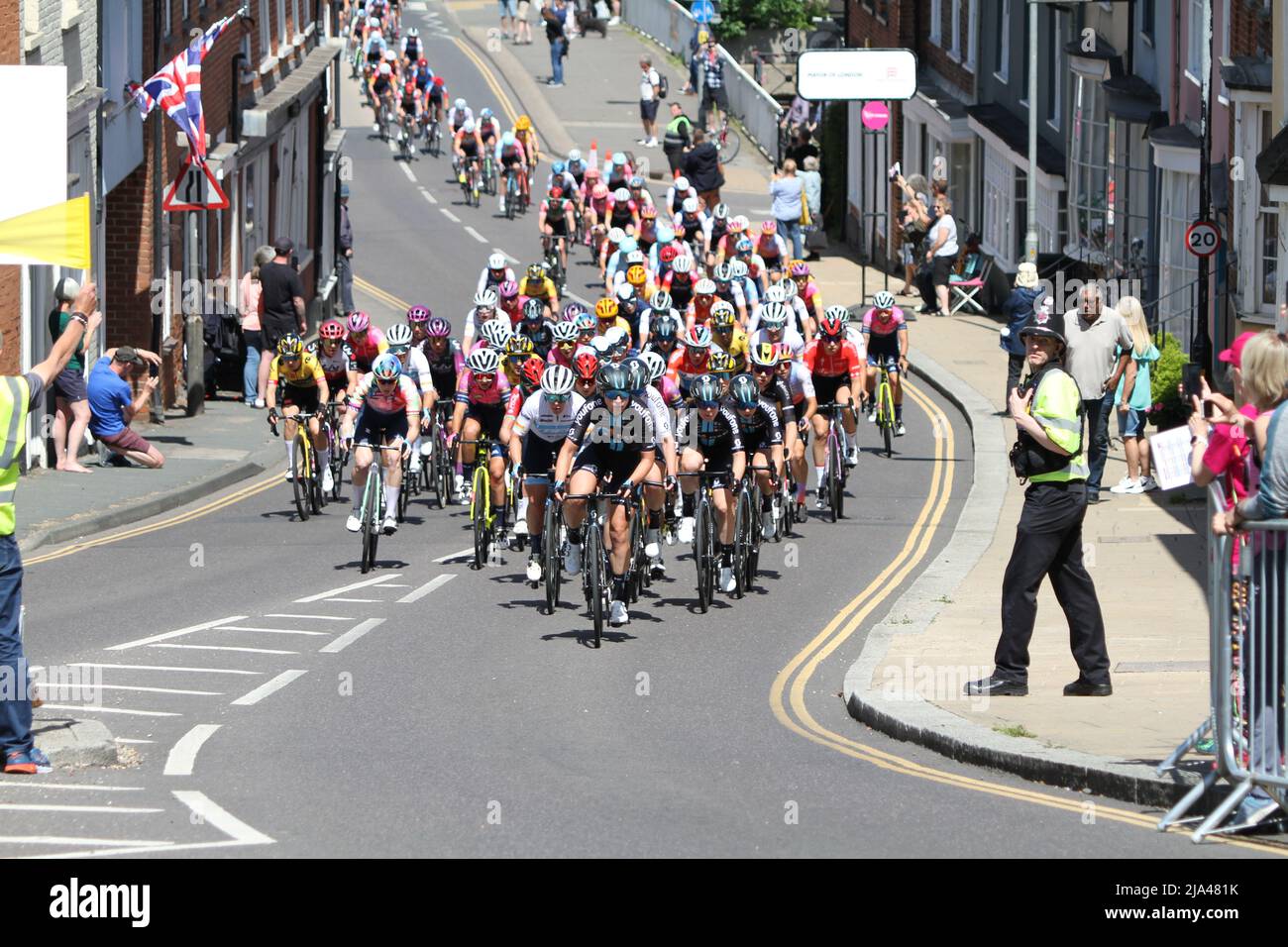 Maldon, UK. 27th May 2022. Stage one of the RideLondon Classique 2022 women's cycle race, part of the UCI Women’s World Tour calendar. The peloton is strung out as they climb up Market Hill in Maldon, Essex. Credit: Eastern Views/Alamy Live News Stock Photo