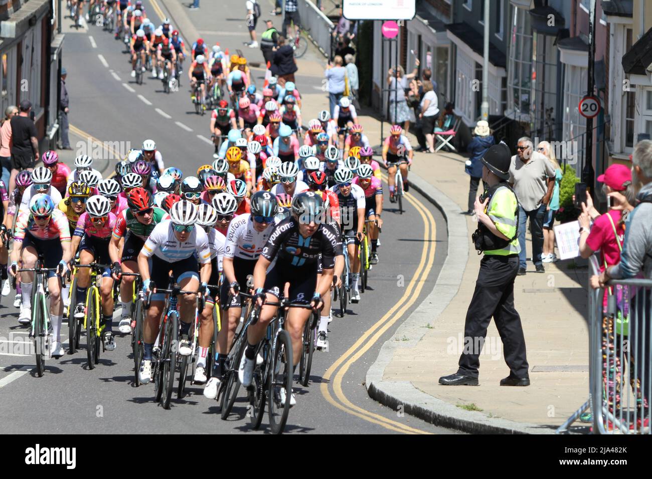 Maldon, UK. 27th May 2022. Stage one of the RideLondon Classique 2022 women's cycle race, part of the UCI Women’s World Tour calendar. The peloton is strung out as they climb up Market Hill in Maldon, Essex. Credit: Eastern Views/Alamy Live News Stock Photo