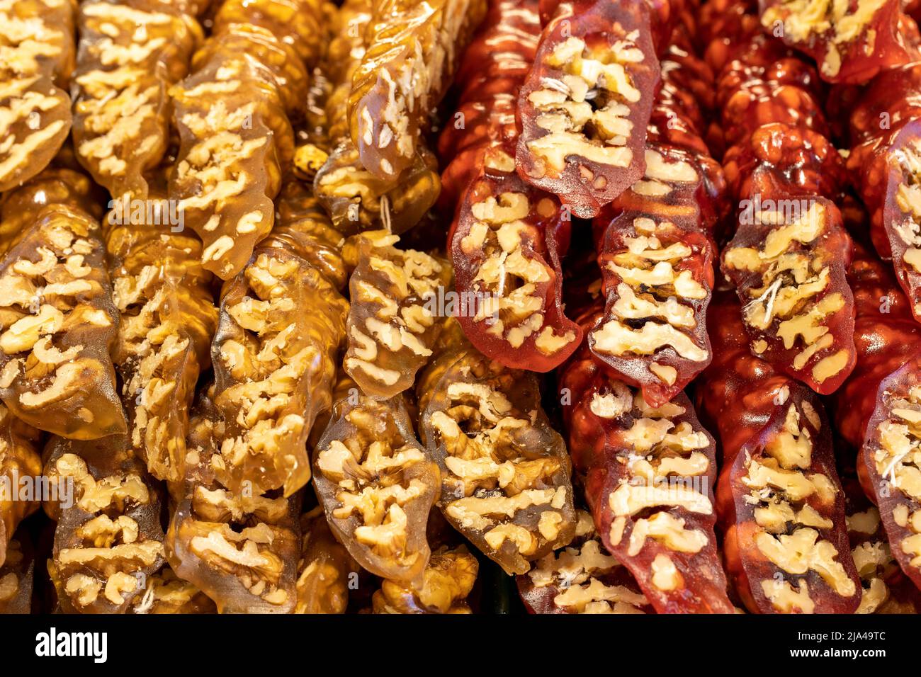 Walnut sausage with pomegranate walnuts and yellow grapes. Sweet snack. Close-up. local name cevizli sucuk Stock Photo