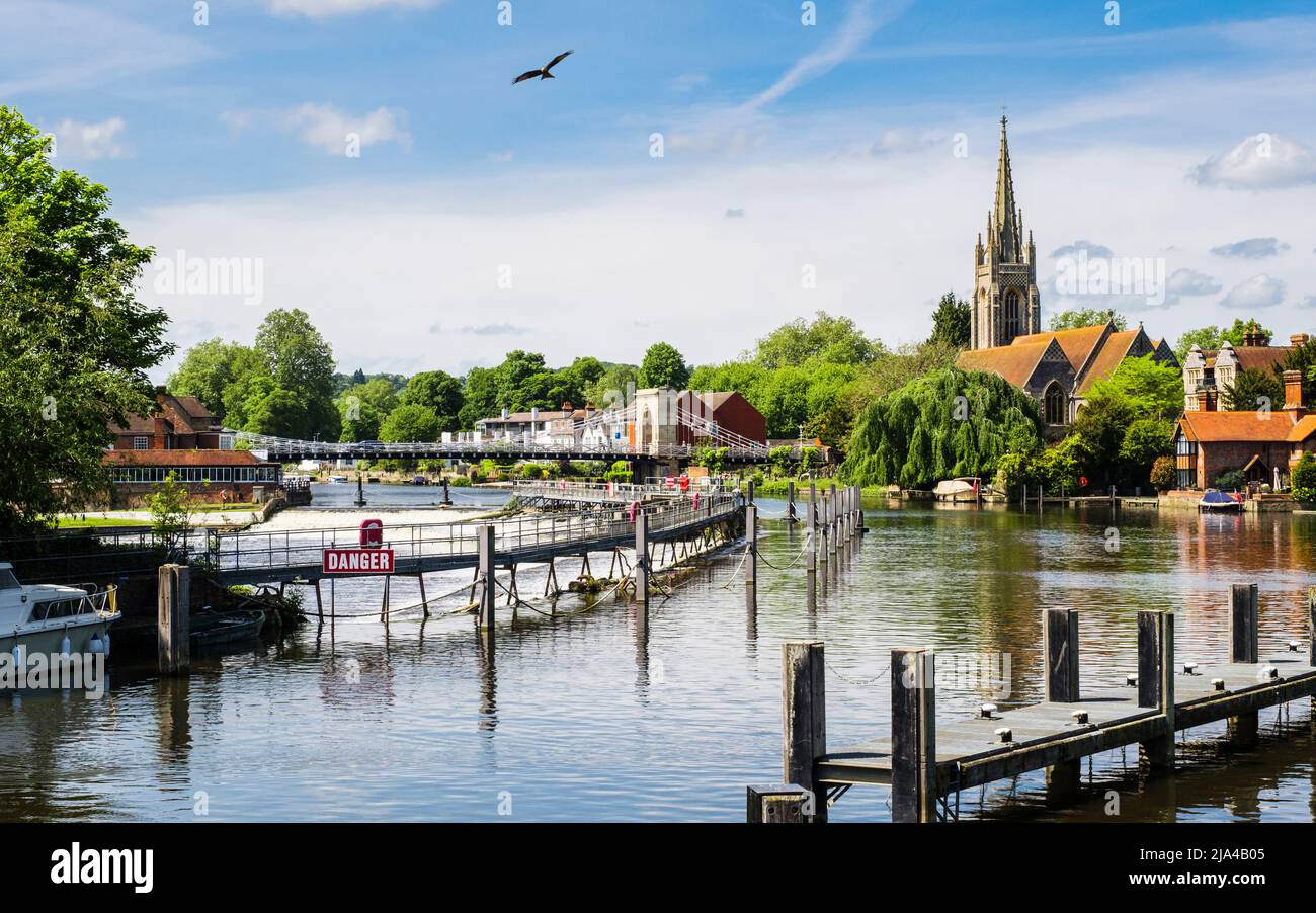 View from Marlow lock along River Thames to suspension bridge and All Saints Church with a Red Kite flying overhead. Marlow Buckinghamshire England UK Stock Photo