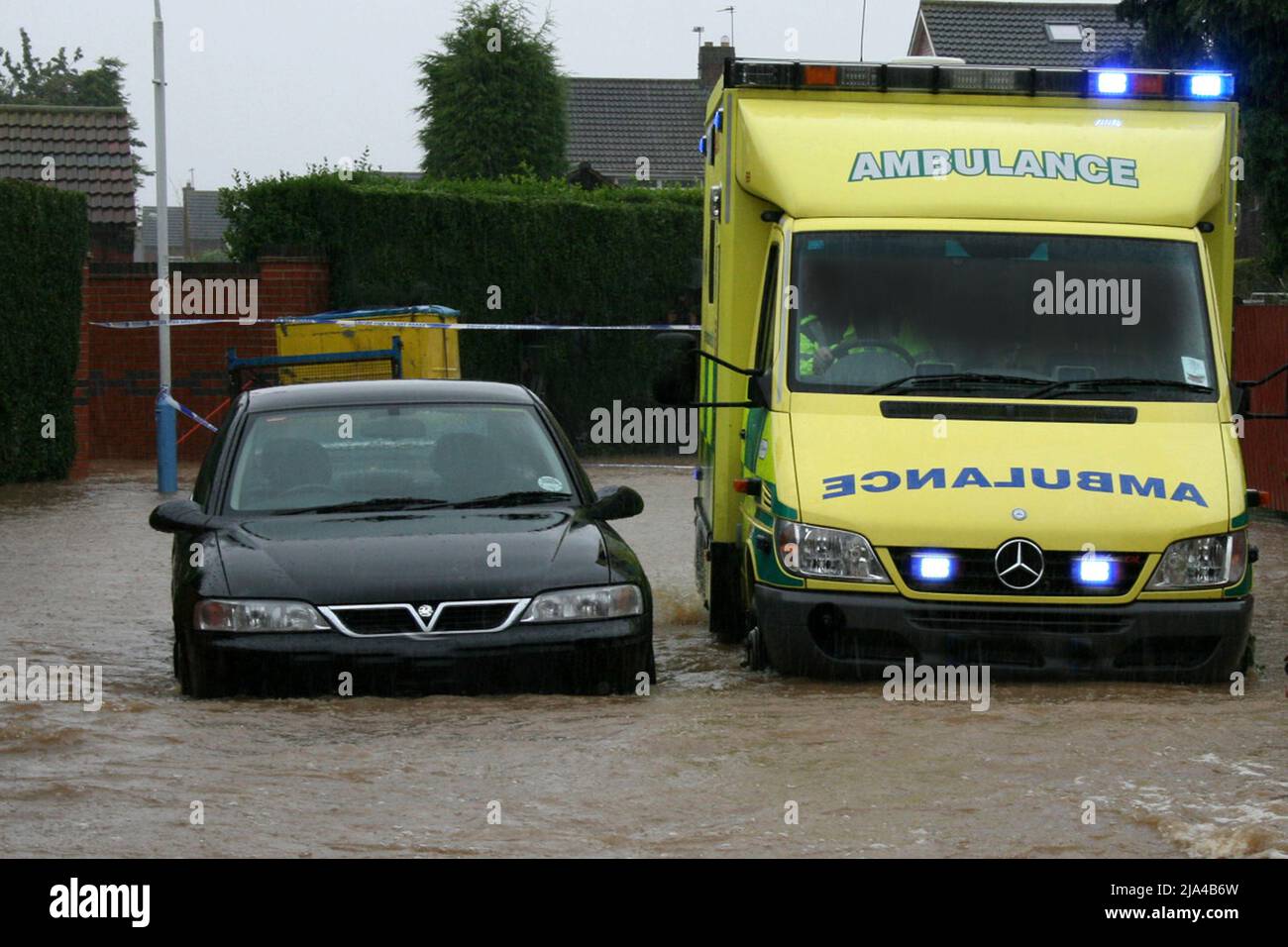 Ambulance in flood water, medical emergency response Stock Photo