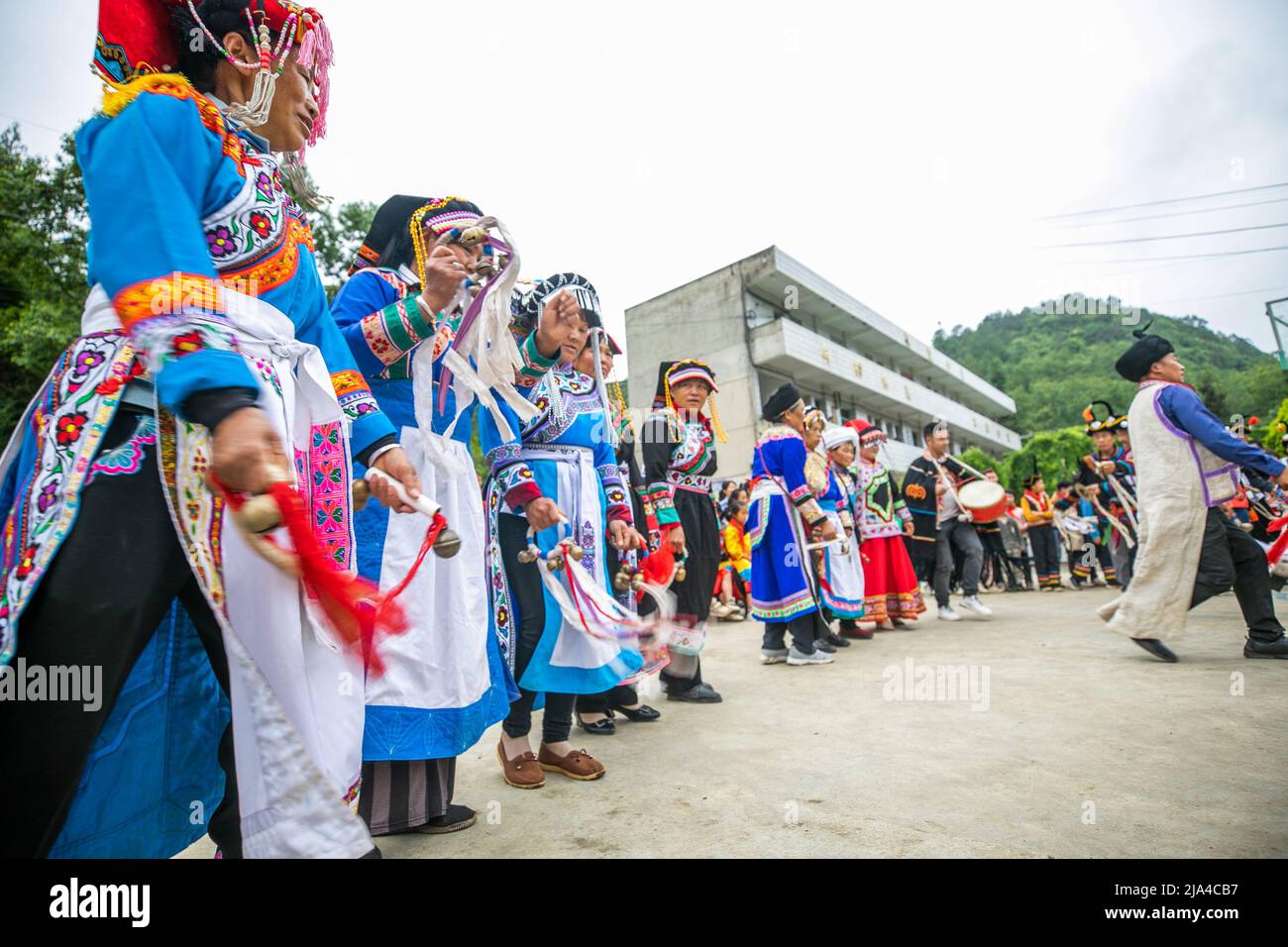 BIJIE, CHINA - MAY 27, 2022 - Villagers of yi ethnic group dance to celebrate international Children's Day at a primary school in Bijie, Southwest Chi Stock Photo