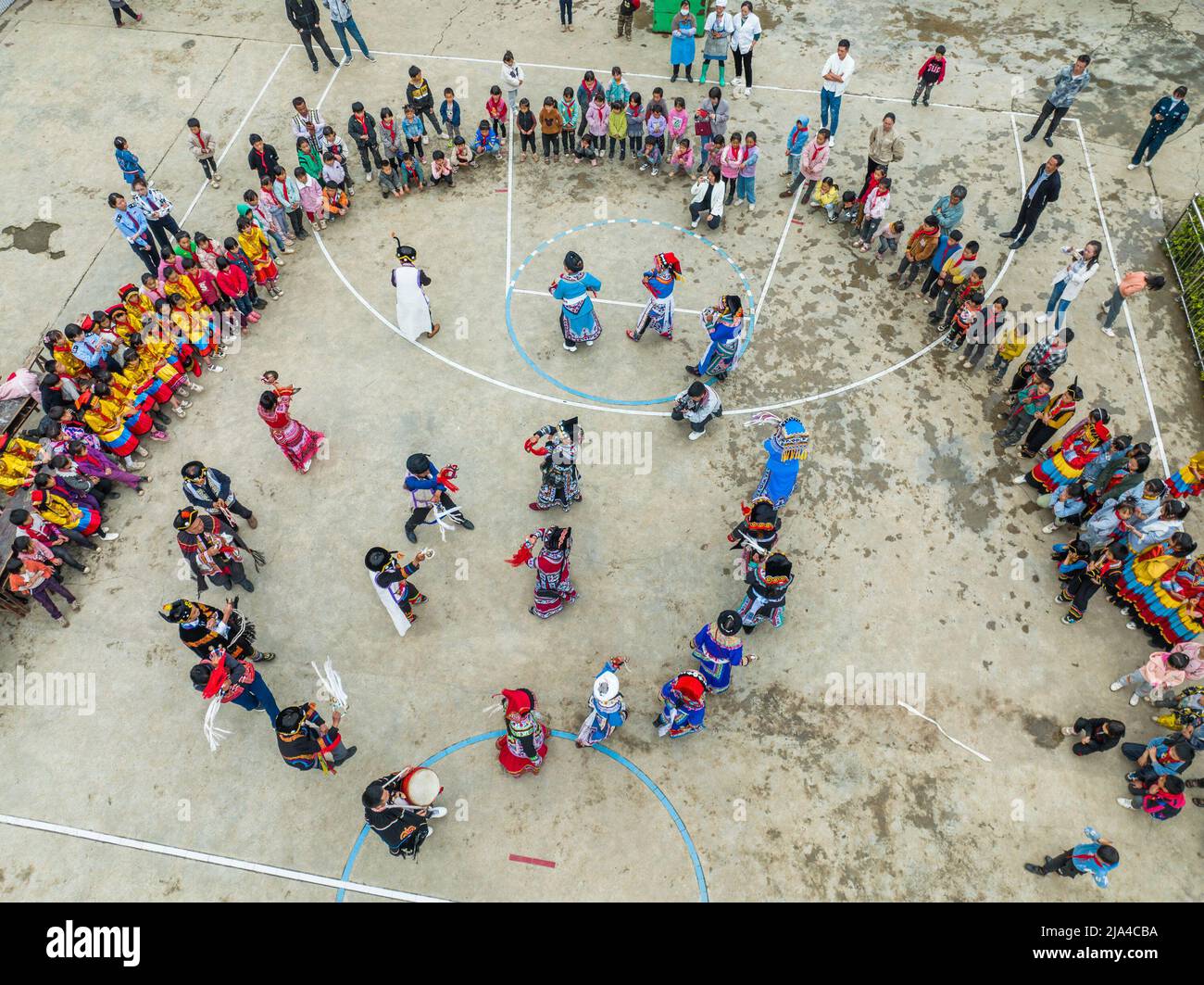 BIJIE, CHINA - MAY 27, 2022 - Villagers of yi ethnic group dance to celebrate international Children's Day at a primary school in Bijie, Southwest Chi Stock Photo