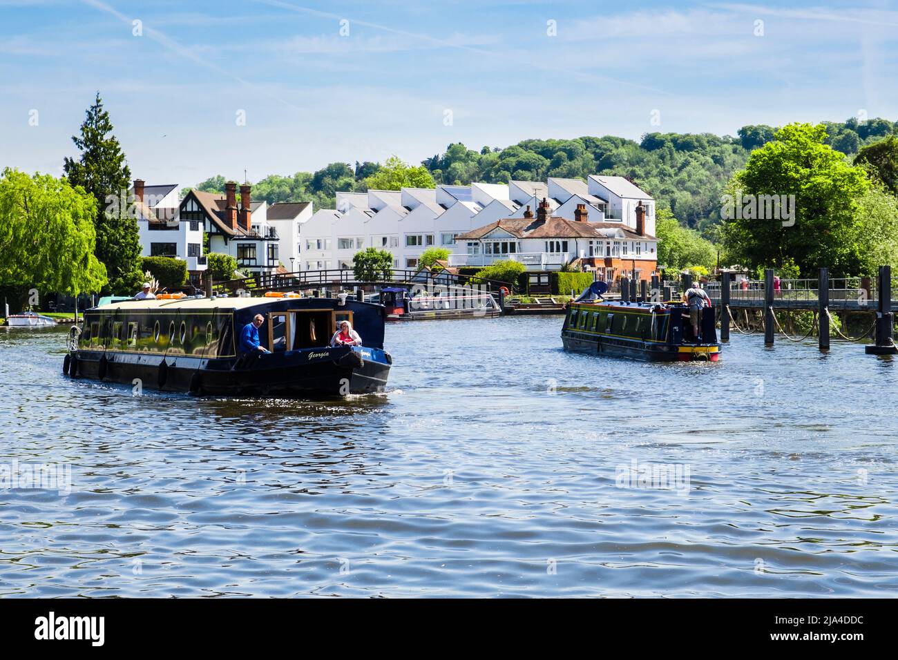 Narrowboat and barge sailing from Marlow lock along River Thames. Marlow, Buckinghamshire, England, UK, Britain Stock Photo