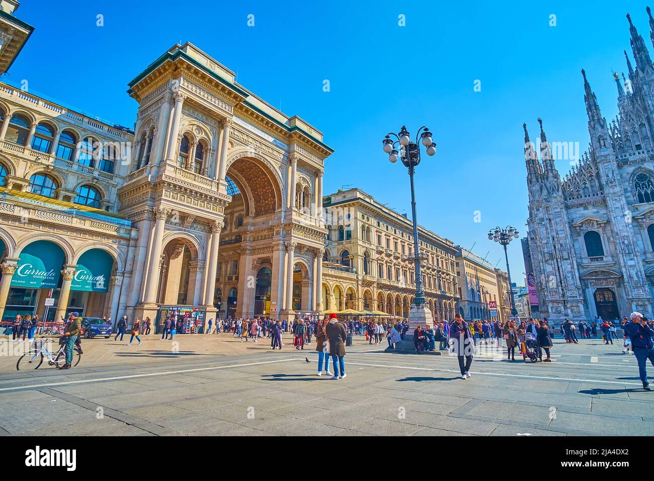 MILAN, ITALY - APRIL 5, 2022: The elegant Triumphal Arch entrance to Galleria Vittorio Emanuele II shopping gallery in Milan, on April 5 in Milan, Ita Stock Photo