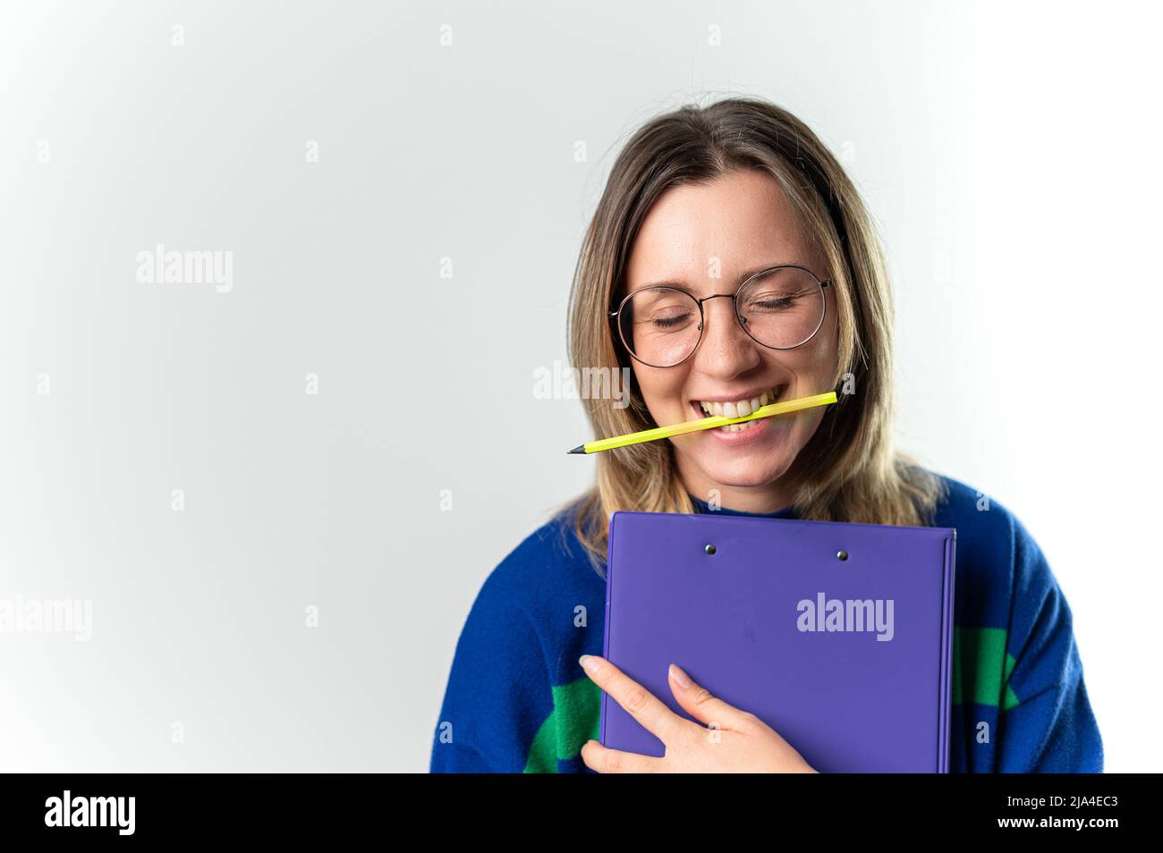 Holding a pencil in her mouth pencil in mouth hi-res stock photography ...