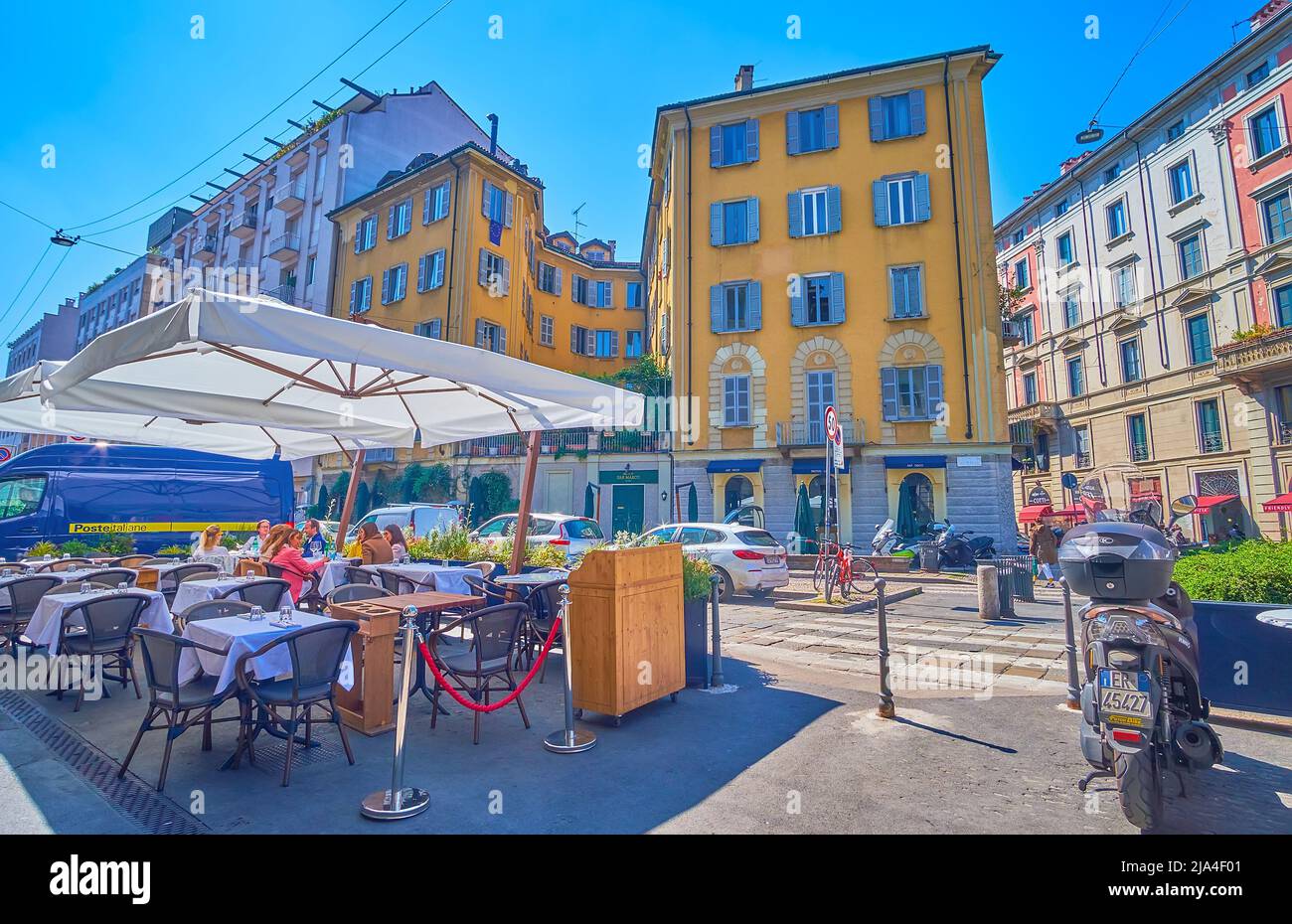 MILAN, ITALY - APRIL 5, 2022: Brera district is famous for its numerous outdoor restaurants in noisy streets, on April 5 in Milan, Italy Stock Photo
