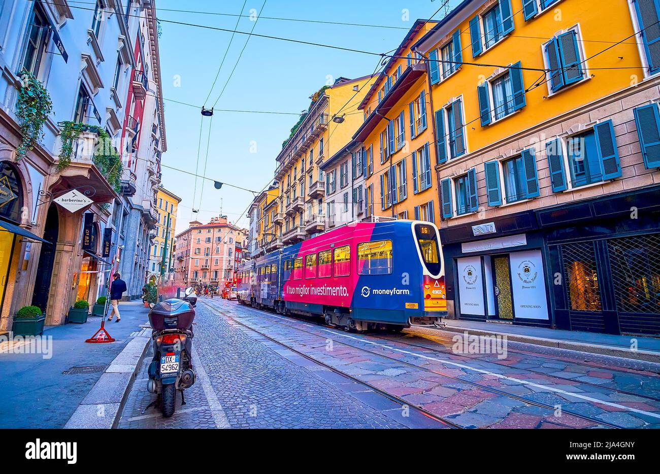 MILAN, ITALY - APRIL 5, 2022: The old tram rides along Corso Magenta street with typical Italian houses, on April 5 in Milan, Italy Stock Photo