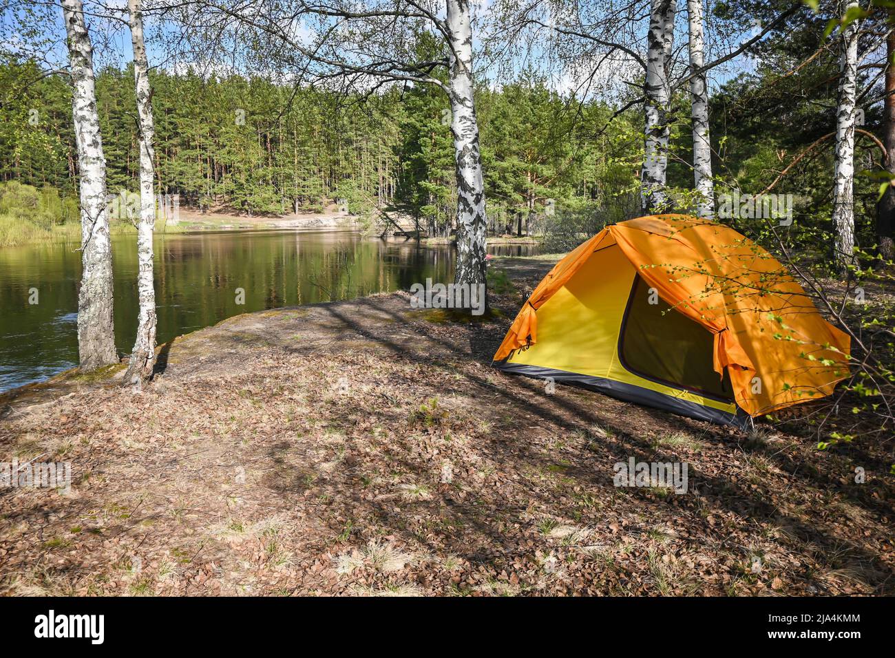 A tent on the river bank. Tourist parking on the spring river Stock ...