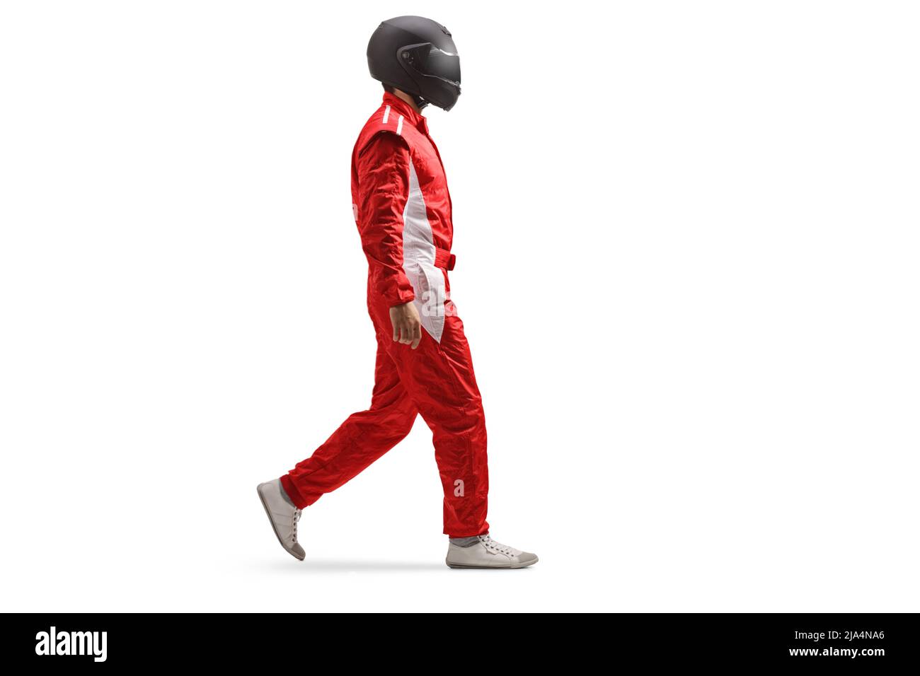 Full length profile shot of a racer in a red suit and black helmet walking isolated on white background Stock Photo