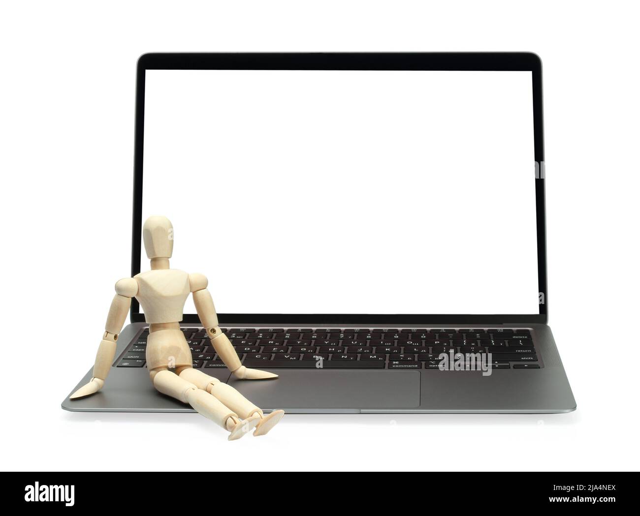 Laptop with blank screen and wooden manikin, on white background close-up Stock Photo