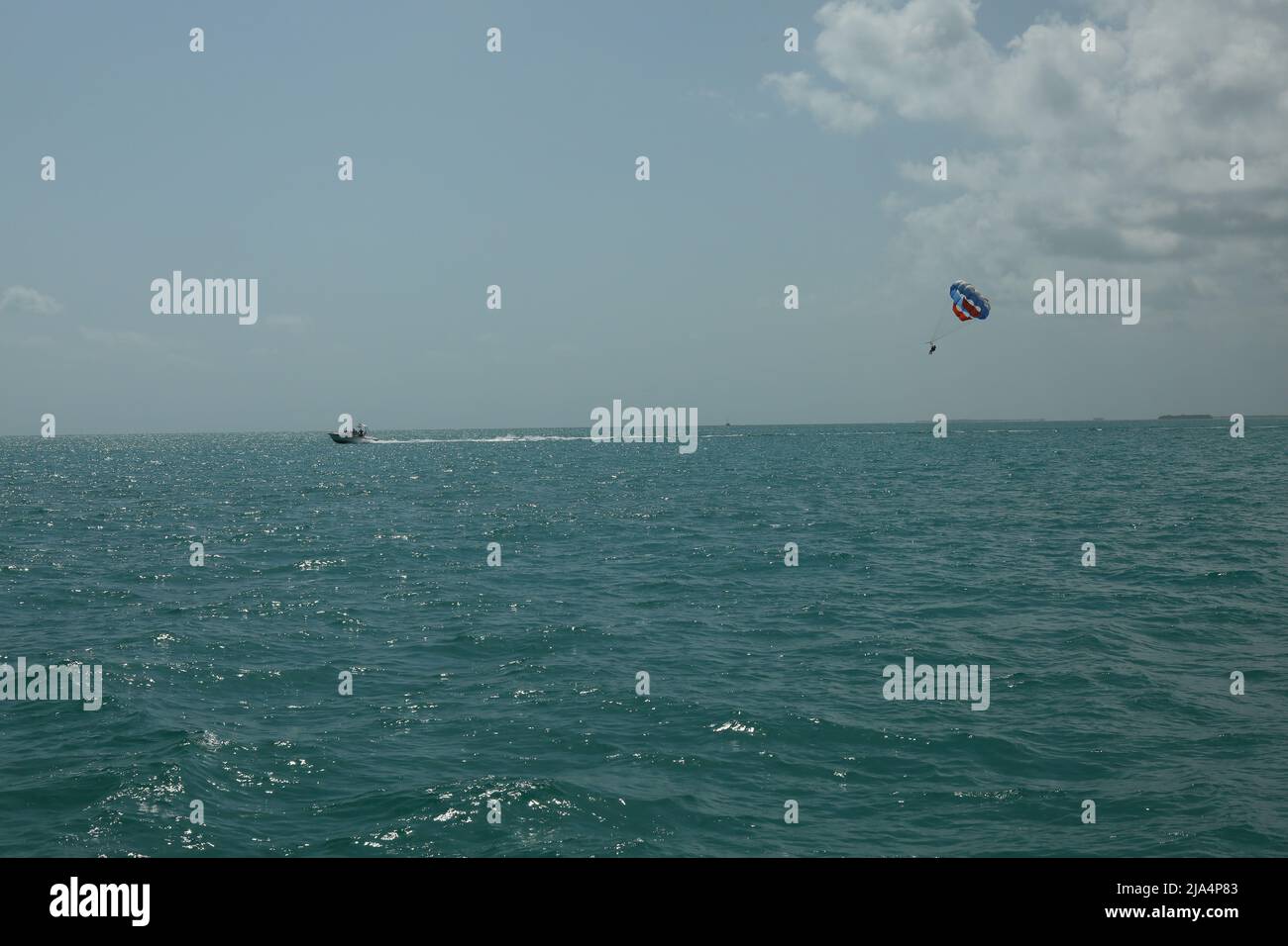 Paragliding in Key West Florida over azure water in sunny nice weather, tours and tickets