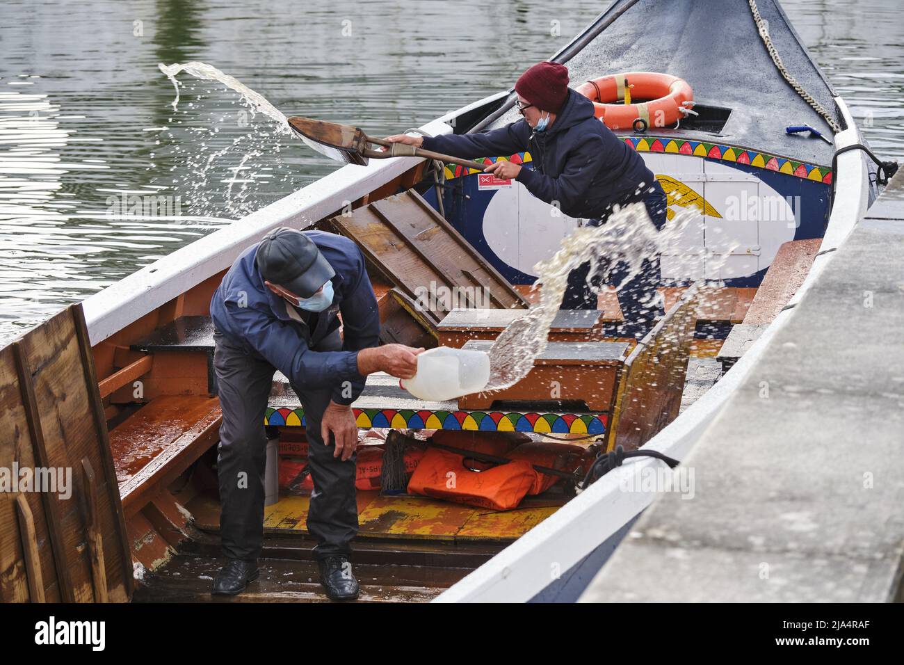 Cleaning Of Moliceiros Boats Before Their Tourist Trip Along Canal In cleaning-of-moliceiros-boats-before-their-tourist-trip-along-canal-in