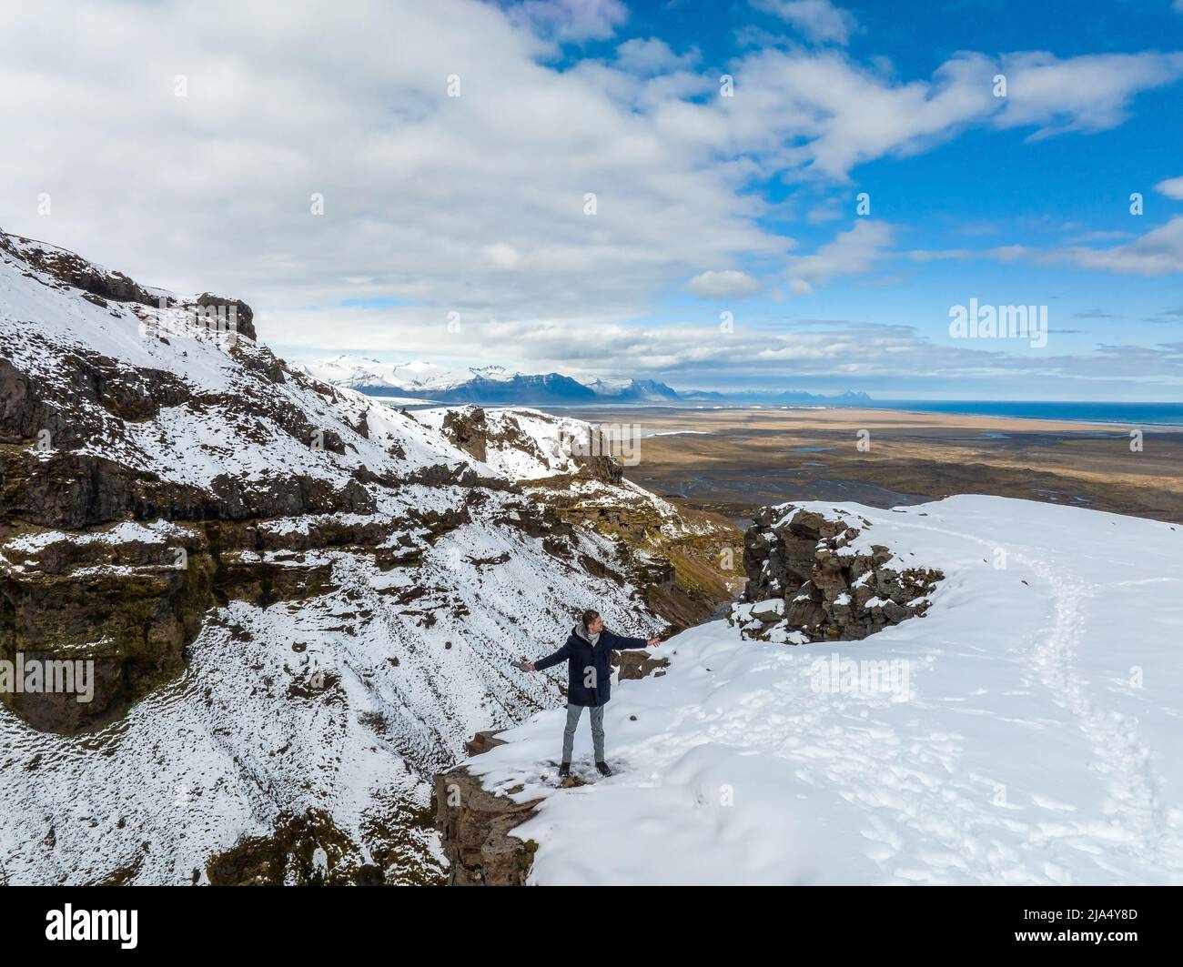 Man standing on top of the cliff in Iceland. Stock Photo