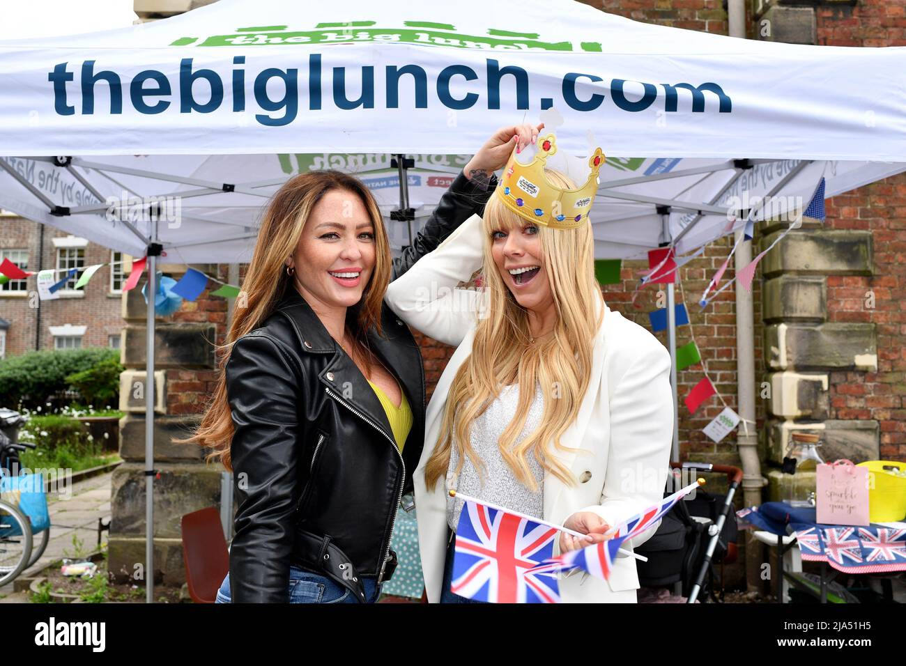 EDITORIAL USE ONLY Members of Atomic Kitten, Liz McClarnon (right) and Natasha Hamilton at 'The Big Cheesy Lunch', a community event hosted by Iceland, official partner of The Big Jubilee Lunch, in Macclesfield as part of The Queen's official Platinum Jubilee celebrations. Picture date: Friday May 27, 2022. Stock Photo