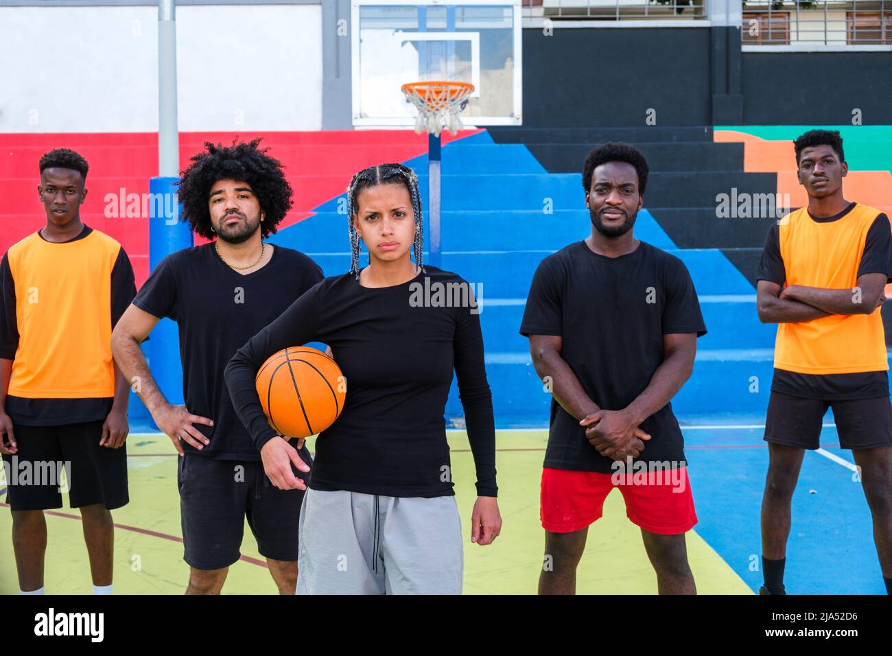 Mixed basketball team waiting to play on the court Stock Photo Alamy