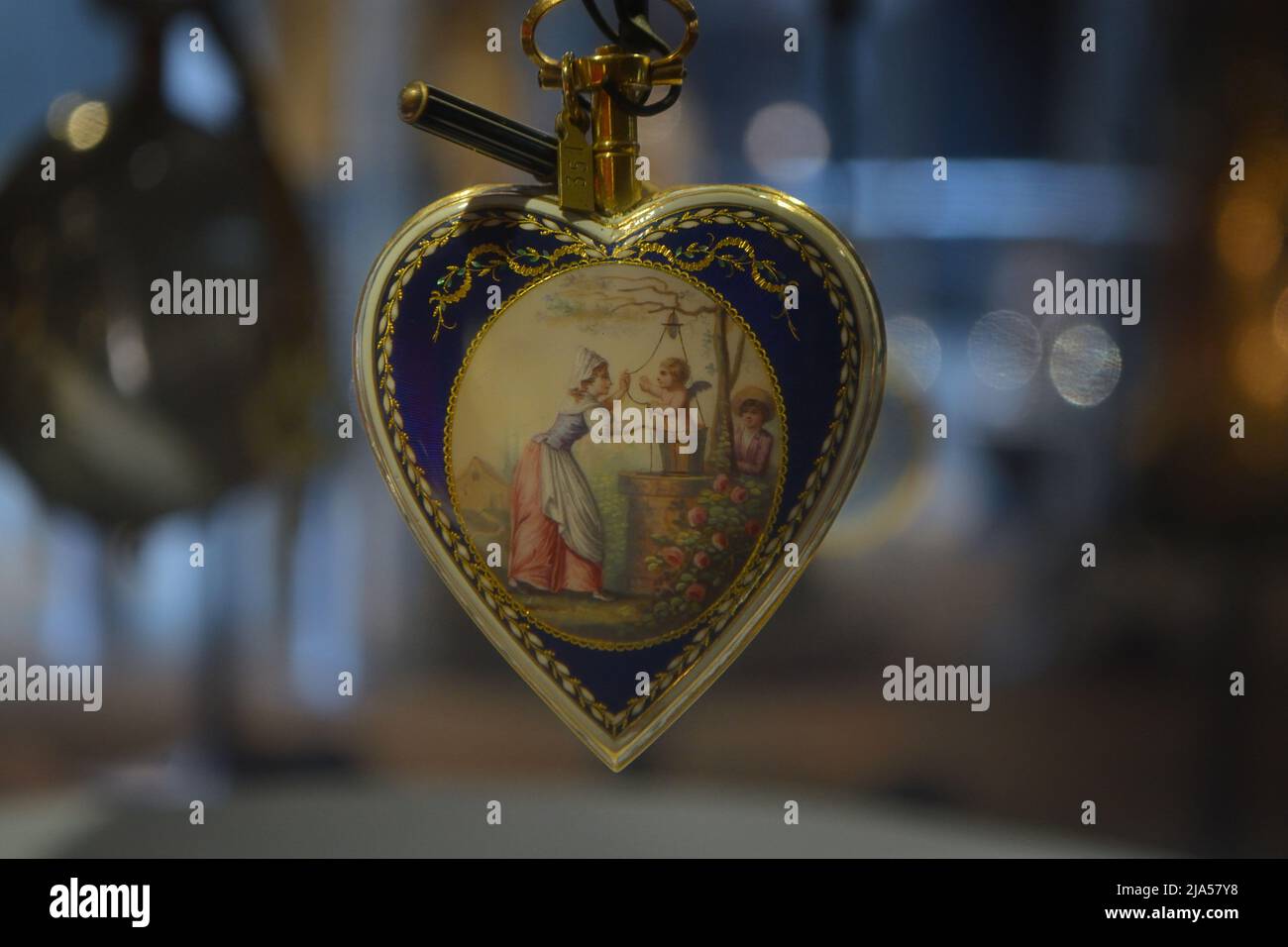 Old pocket watch, in heart shape with a painting on it Stock Photo - Alamy