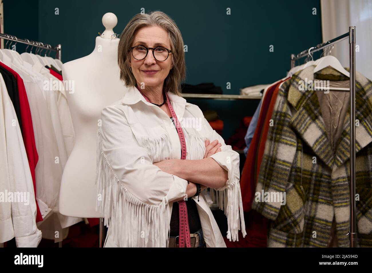 Mature creative gray haired European woman fashion designer tailor