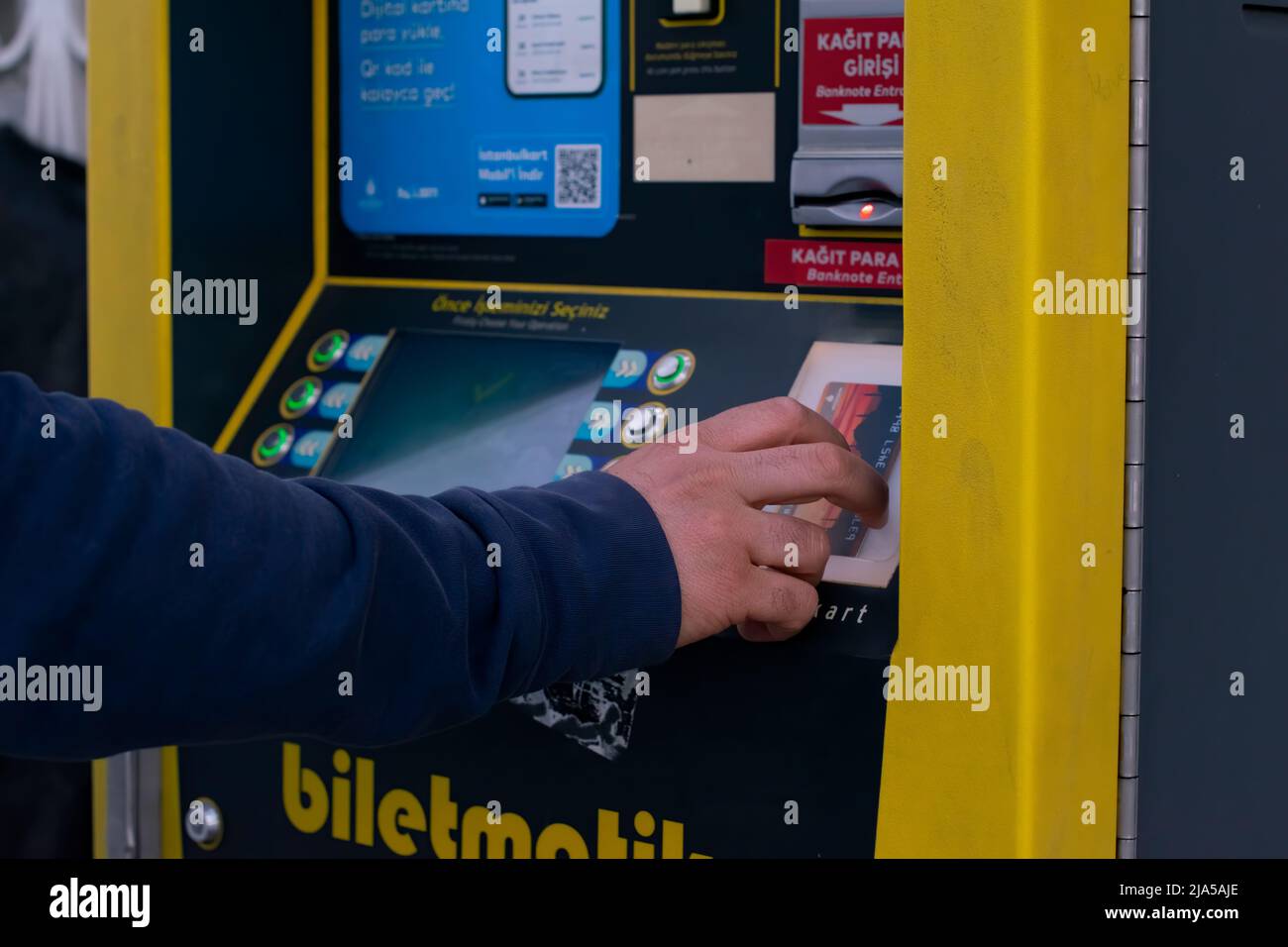 ISTANBUL,TURKEY-May 24,2022:Turkish man paying at ticket machine in a bus station. Stock Photo