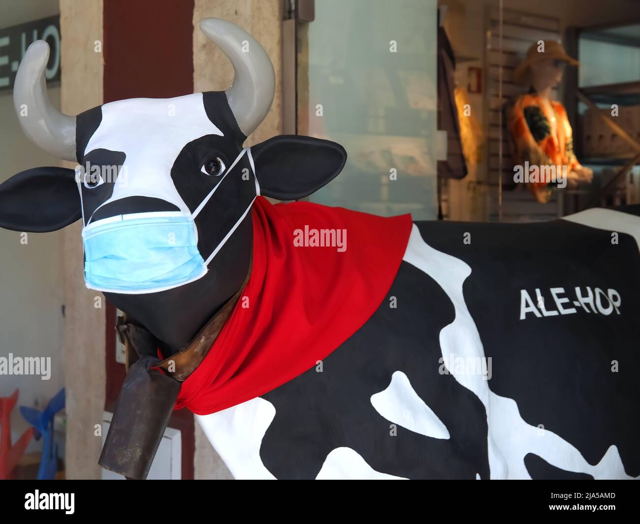 Funny cow of the Alehop store in Portugal with a Corona face mask Stock Photo