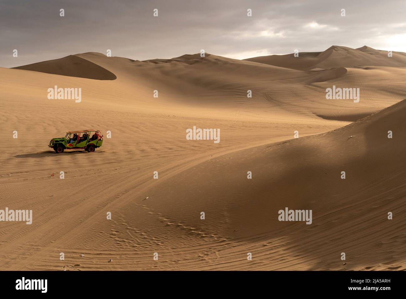 A Dune Buggy On The Sand Dunes Near The Desert Oasis Village Of Huacachina, Ica Province, Peru. Stock Photo