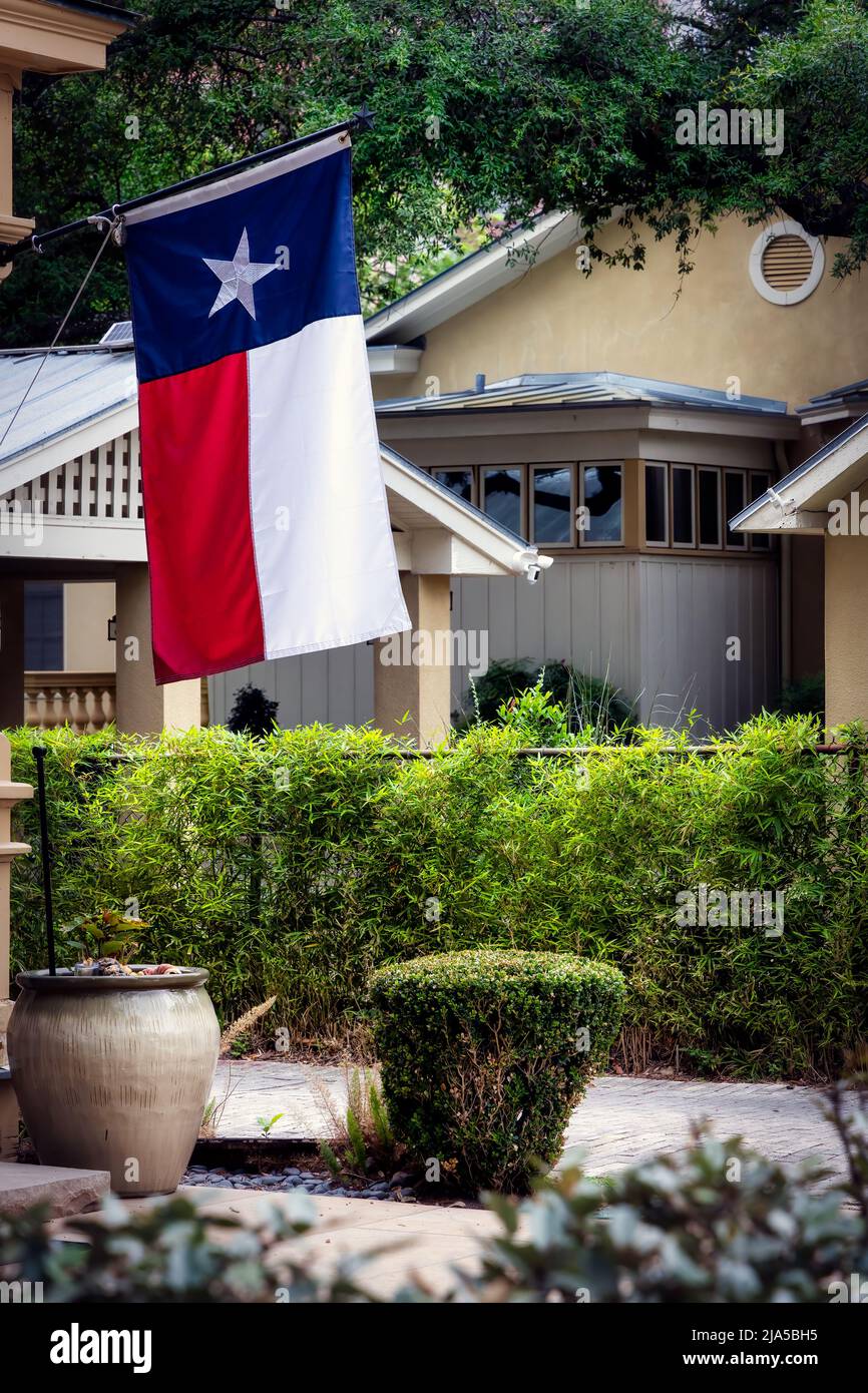 A Texas state flag, or Lonestar flag, hangs proudly at the King William Historic District in San Antonio, Texas. Stock Photo