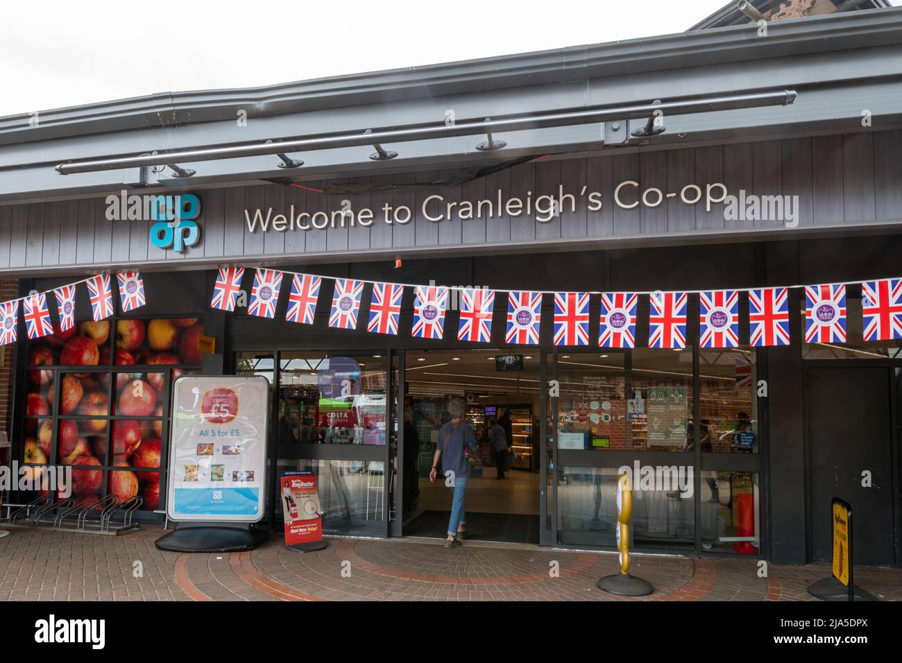 Queen Elizabeth II Platinum Jubilee bunting, Cranleigh Co-op supermarket decorations, Surrey, England, UK, 2022 Stock Photo