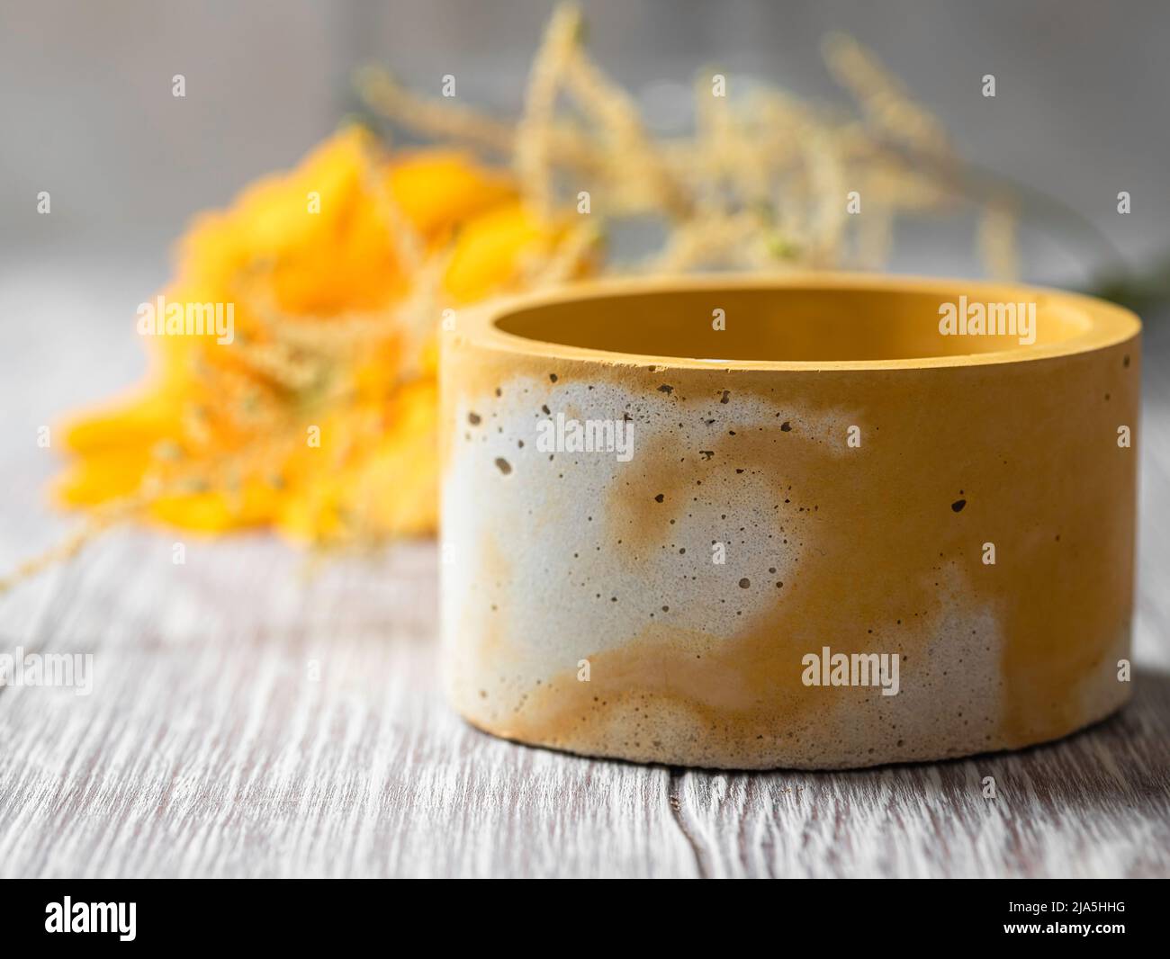 Handmade pots made of gray and yellow concrete. Cache-pot for plants, for succulents. Candlestick. Scandinavian interior. Selective focus Stock Photo