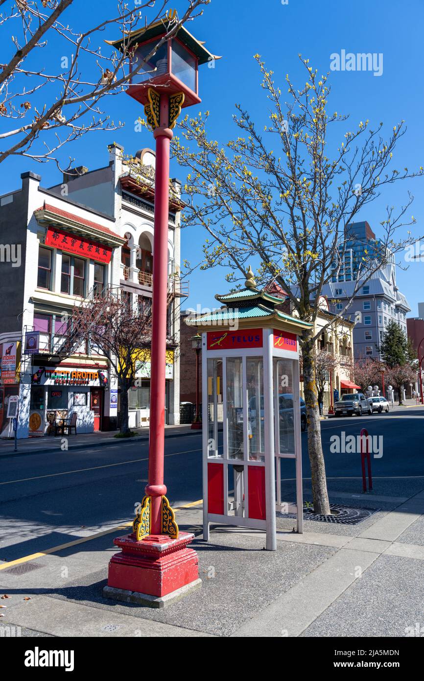 Victoria, BC, Canada - April 14 2021 : Chinese style telephone booth and street light in Victoria Chinatown. Stock Photo
