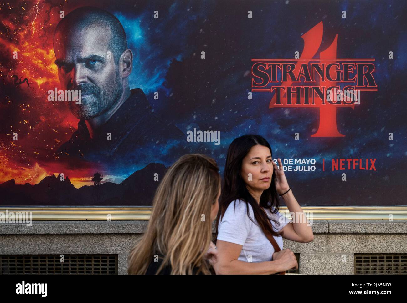 Madrid, Spain. 28th May, 2022. Pedestrians walk past a street commercial advertisement banner from the American global on-demand Internet streaming media provider Netflix featuring Stranger Things Season 4 TV show in Spain. Credit: SOPA Images Limited/Alamy Live News Stock Photo