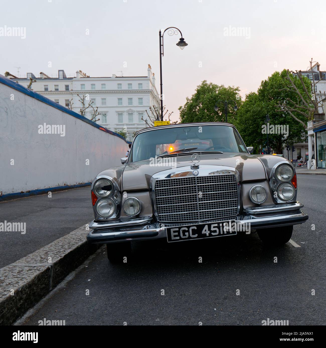 Grey Classic Mercedes Luxury car with chrome grill and headlight