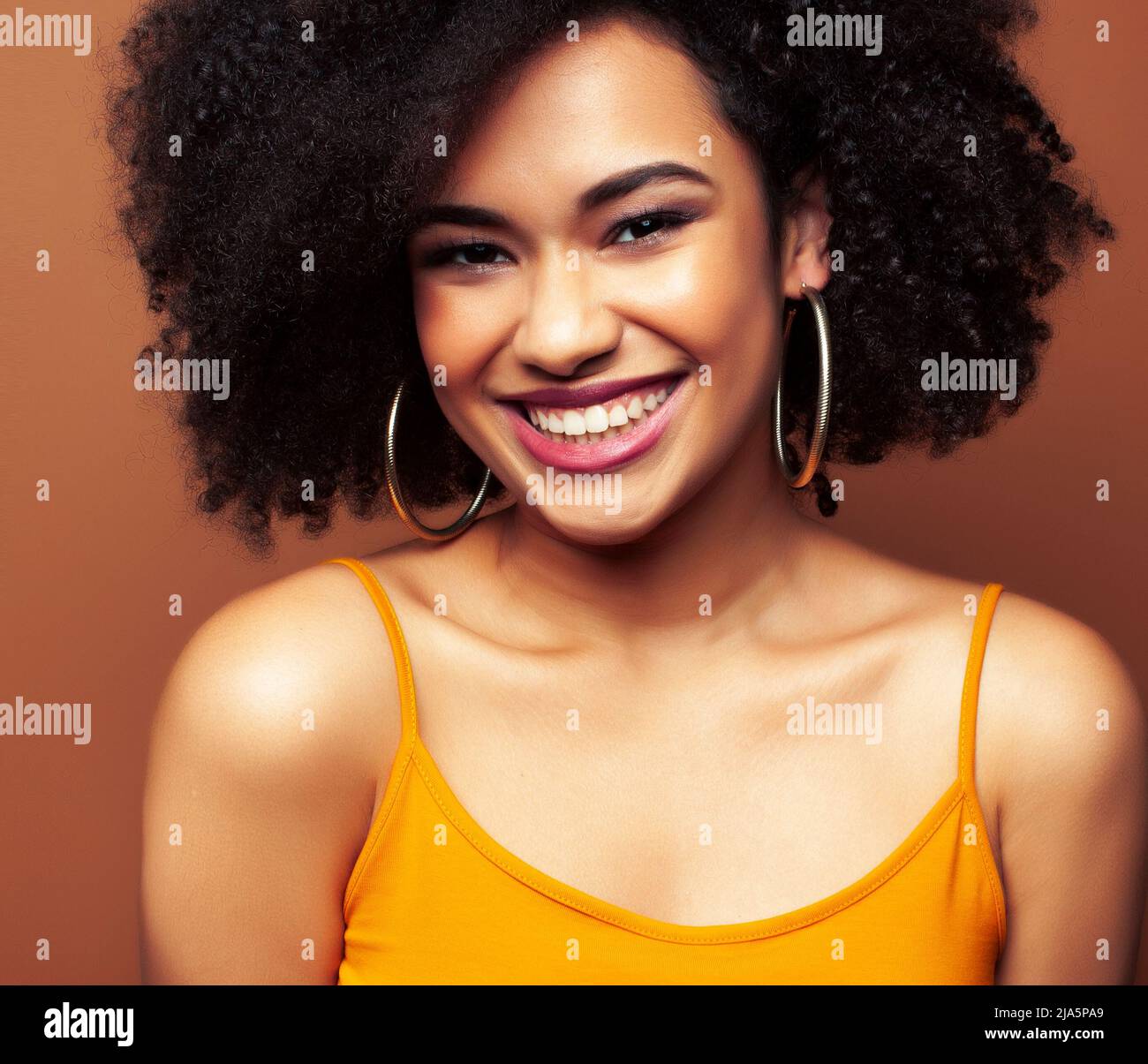 pretty young african american woman with curly hair posing cheerful ...