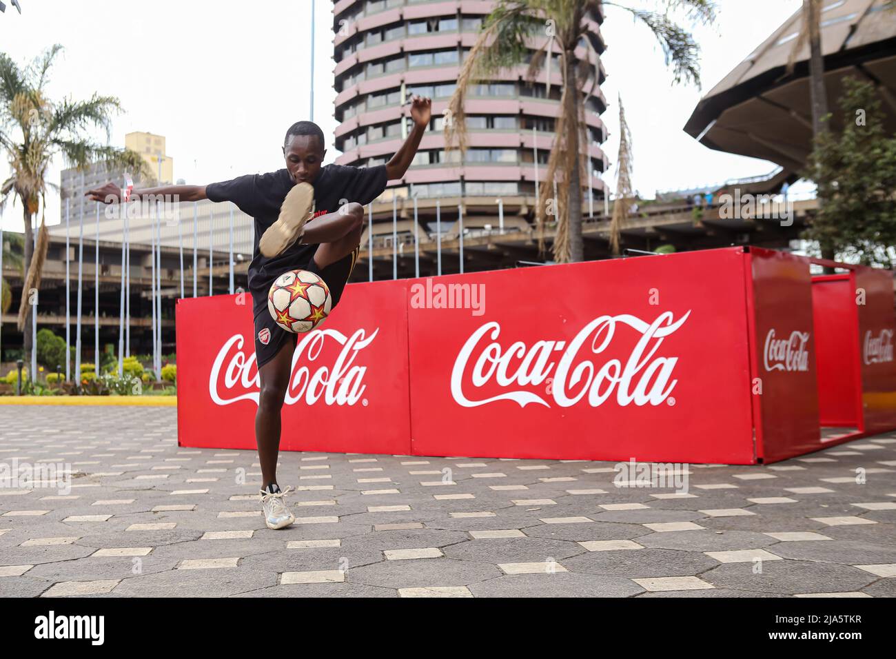 18 year old Kenyan Austin Kinoo, juggles a soccer ball, during the FIFA World Cup tour public