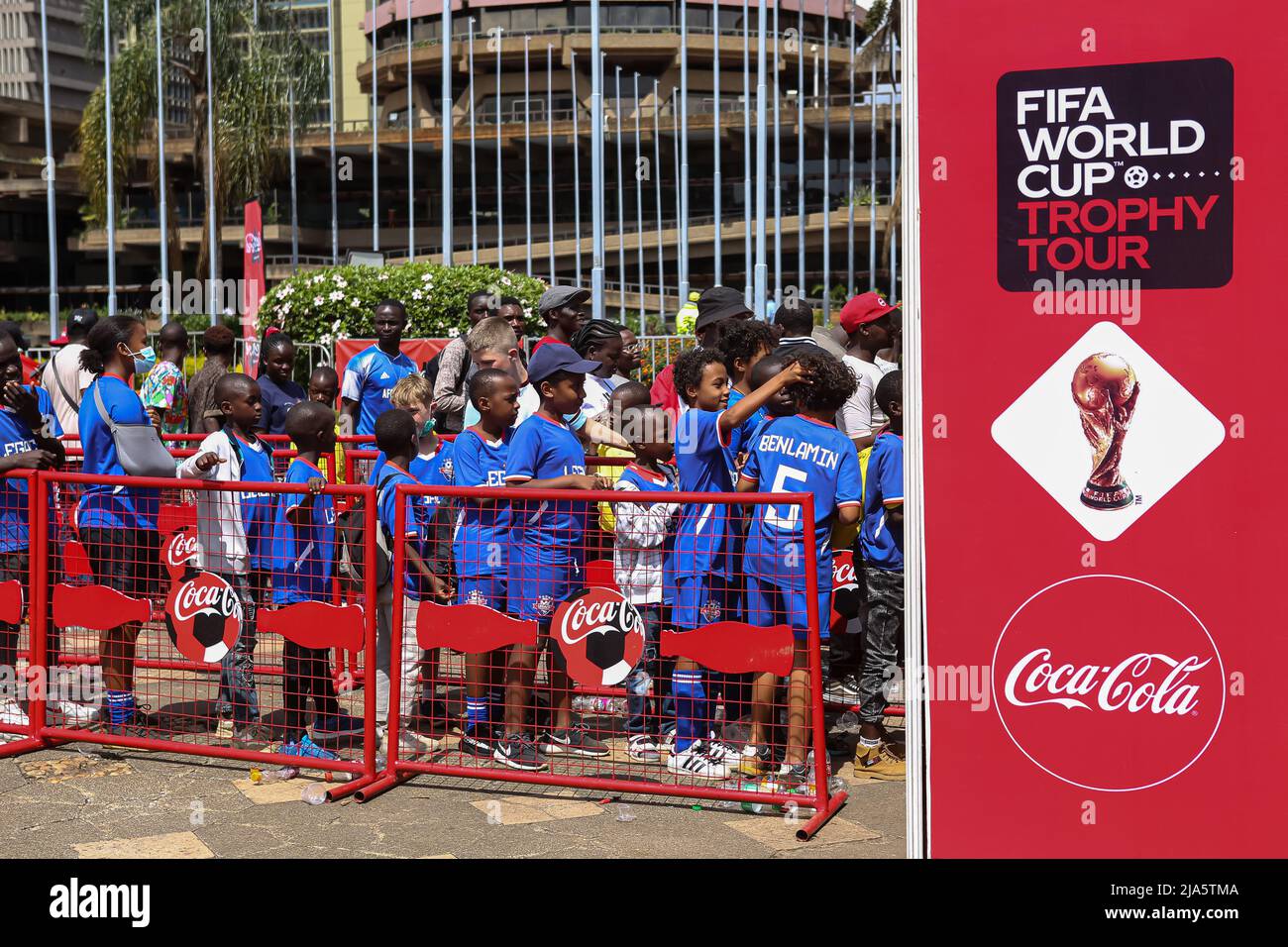 Kenyan children soccer fans queue to view the trophy during the FIFA