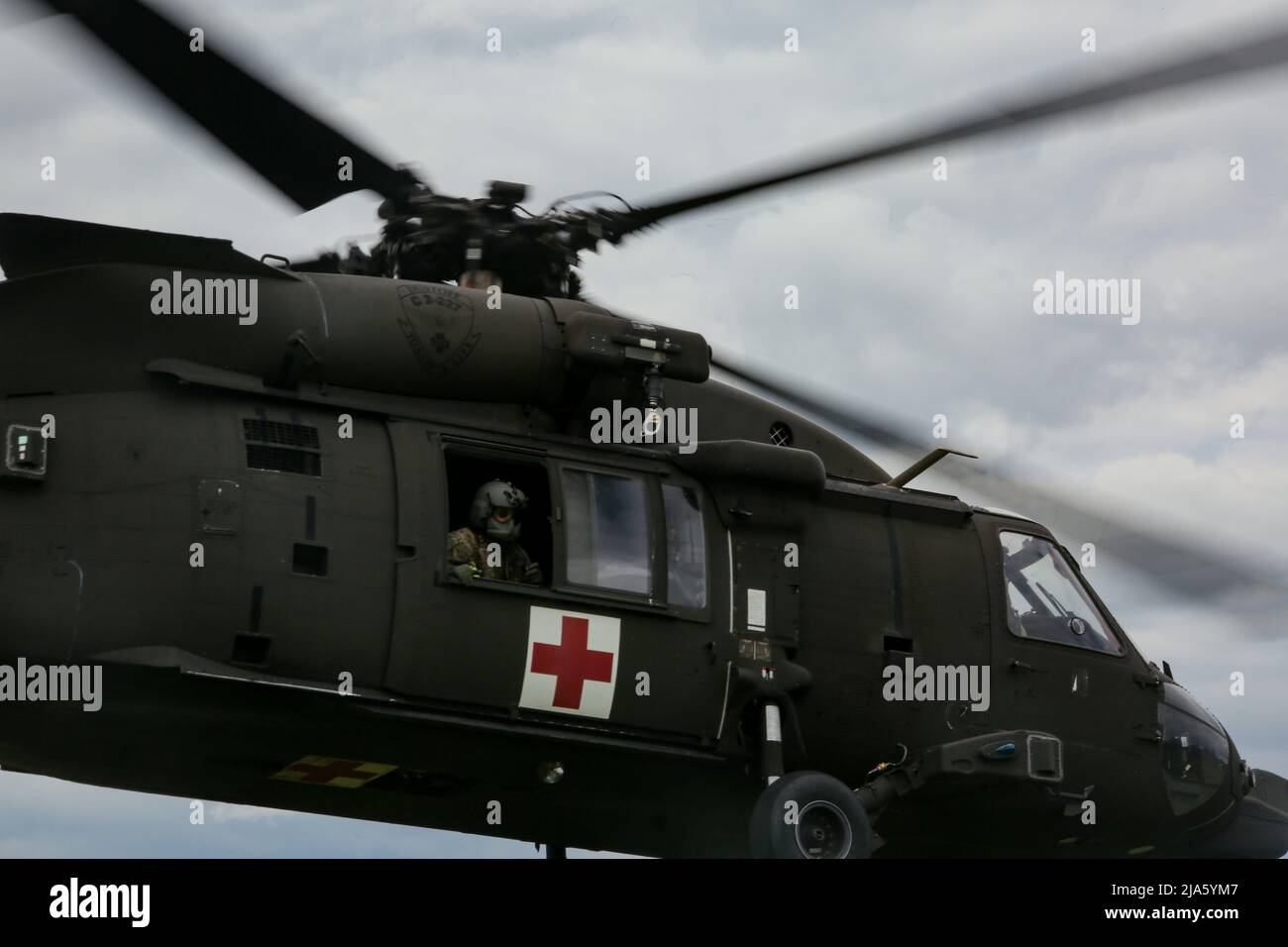 U.S. Soldiers conduct medical evacuation training in a MH-60 Blackhawk during Exercise Combined Resolve 17 (CbR 17) at Hohenfels Training Area, Joint Multinational Readiness Center (JMRC) in Hohenfels, Germany, May 26, 2022. CbR 17 is a United States Army Europe-Africa directed, 7th Army Training Command executed exercise that takes place at JMRC from May 20 to June 19, 2022. The event is designed to evaluate and assess a unit's ability to conduct operations in a complex, multi-domain simulated battle space. The focus of the rotation is to exercise combined arms operations in a multinational e Stock Photo
