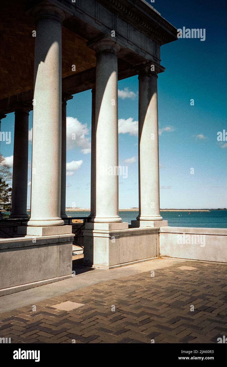 he historic Plymouth Rock monument against a rich blue ocean sky at Plymouth Harbor. Plymouth Massachusetts. The image was captured on analog color fi Stock Photo