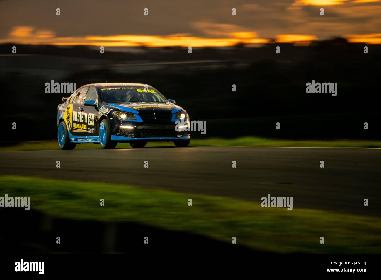 Sydney, Australia. 27 May, 2022. Chris Lillis piloting his Cachet Homes 2019 HSV Clubsport through turn 3 at Sydney Motorsport Park as the sun sets. Credit: James Forrester / Alamy Live News. Stock Photo