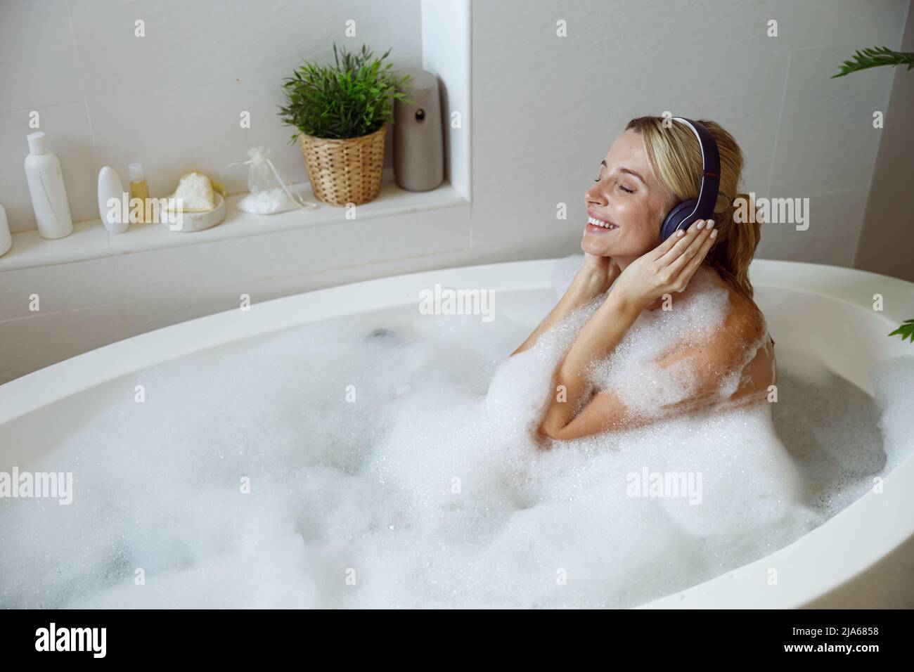 Young blonde woman in bathtub hi-res stock photography and images - Alamy