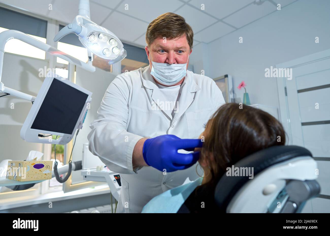 patient is sitting in a chair at a dentist appointment Stock Photo Alamy