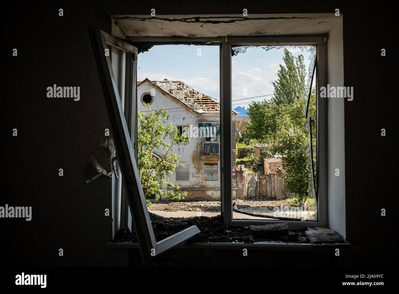 Bakhmut, Ukraine. 24th May, 2022. A view from the window of a residential building destroyed by Russian shelling in Bakhmut, Donbas. As Bakhmut stands as a key city to Ukrainian forces in defending Donetsk(Donbas) region, the city is under attack by the Russian troops. The Russian invasion of Ukraine started on February 24, the war that has killed numerous civilians and soldiers. Credit: SOPA Images Limited/Alamy Live News Stock Photo