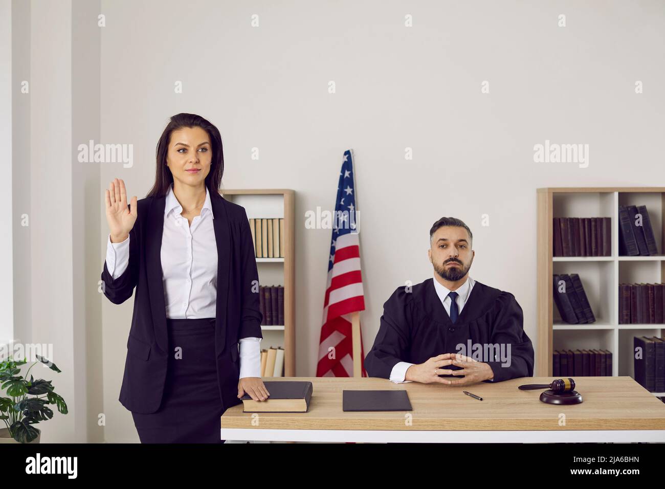 Female witness swears before testifying that she will tell truth and ...