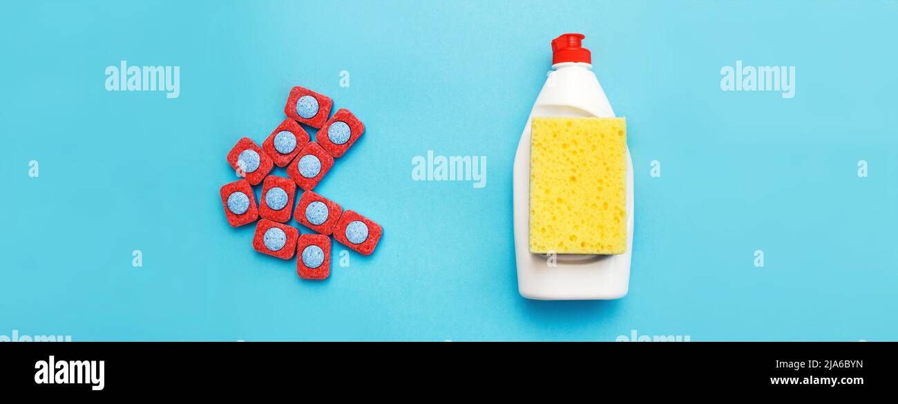 capsules for dishwashers, dishwashing detergents liquid and sponges on a blue background. dishwasher vs hand wash concept. which is better. flat lay. Stock Photo