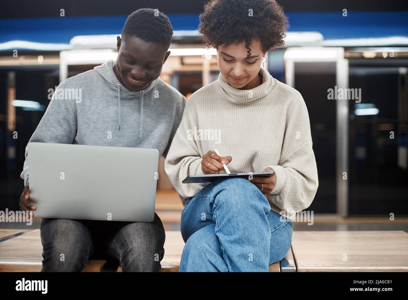 cute young couple with a digital tablet sitting in a subway car. Stock Photo