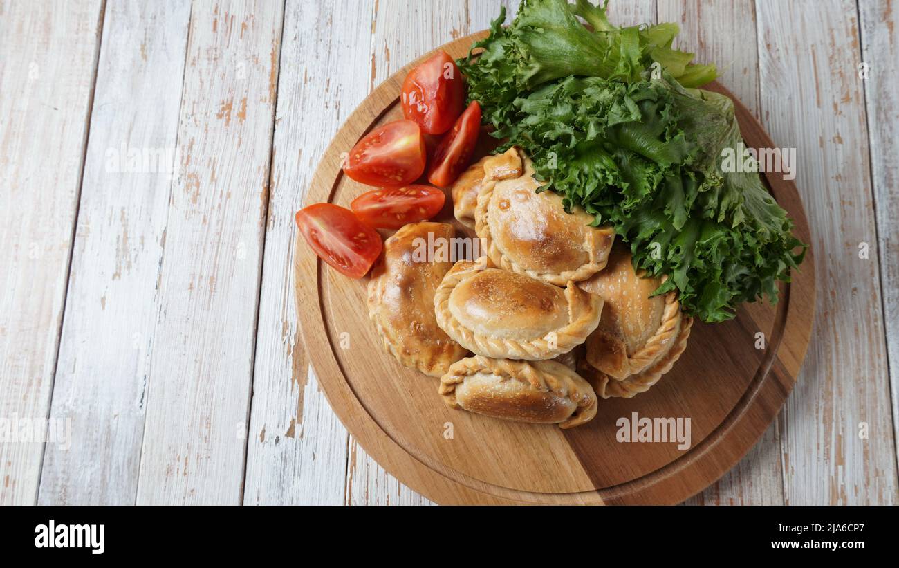Latin American fried empanadas with tomato sauce. Argentinian Empanada