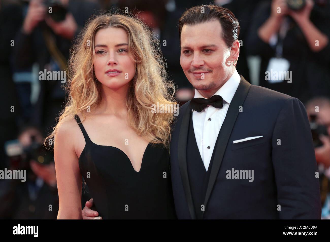 Actor Johnny Depp and his wife Amber Heard arrive for the red carpet event for the movie 'Black Mass' at the 72nd Venice Film Festival. Stock Photo