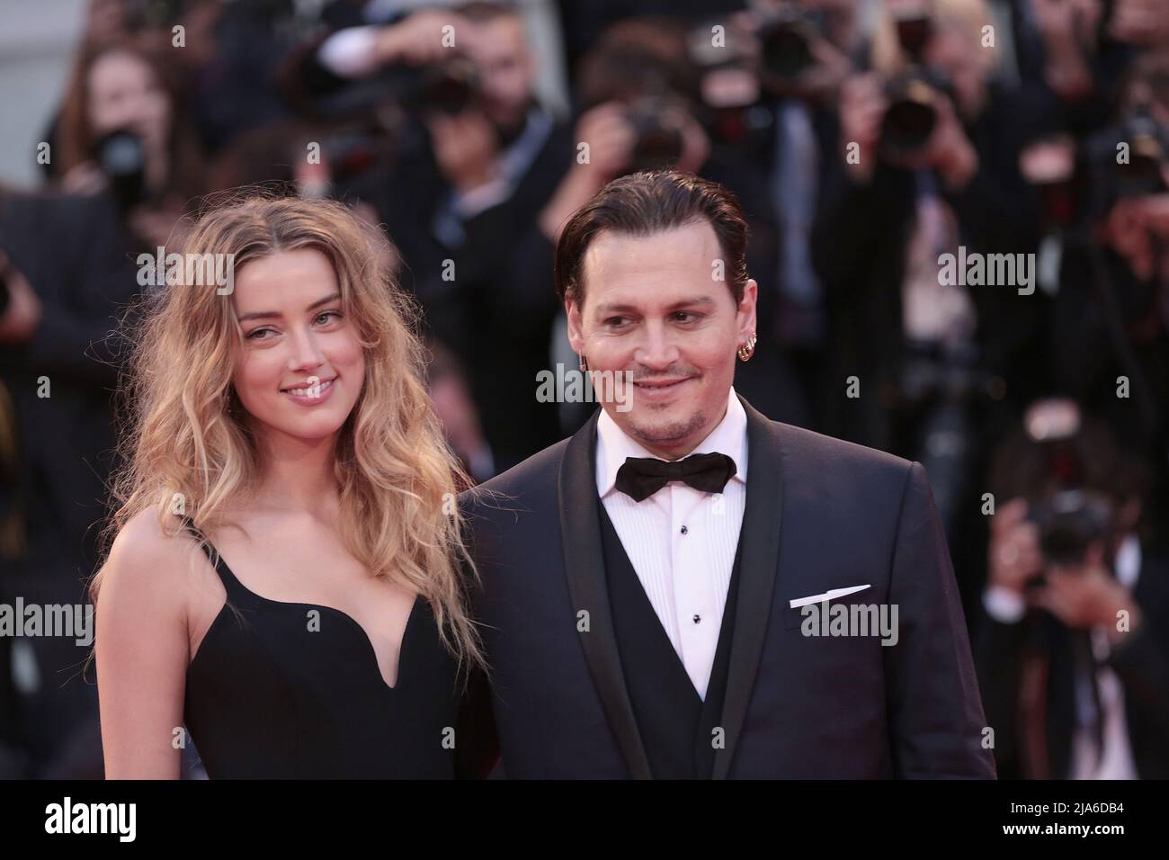 Actor Johnny Depp and his wife Amber Heard arrive for the red carpet event for the movie 'Black Mass' at the 72nd Venice Film Festival. Stock Photo